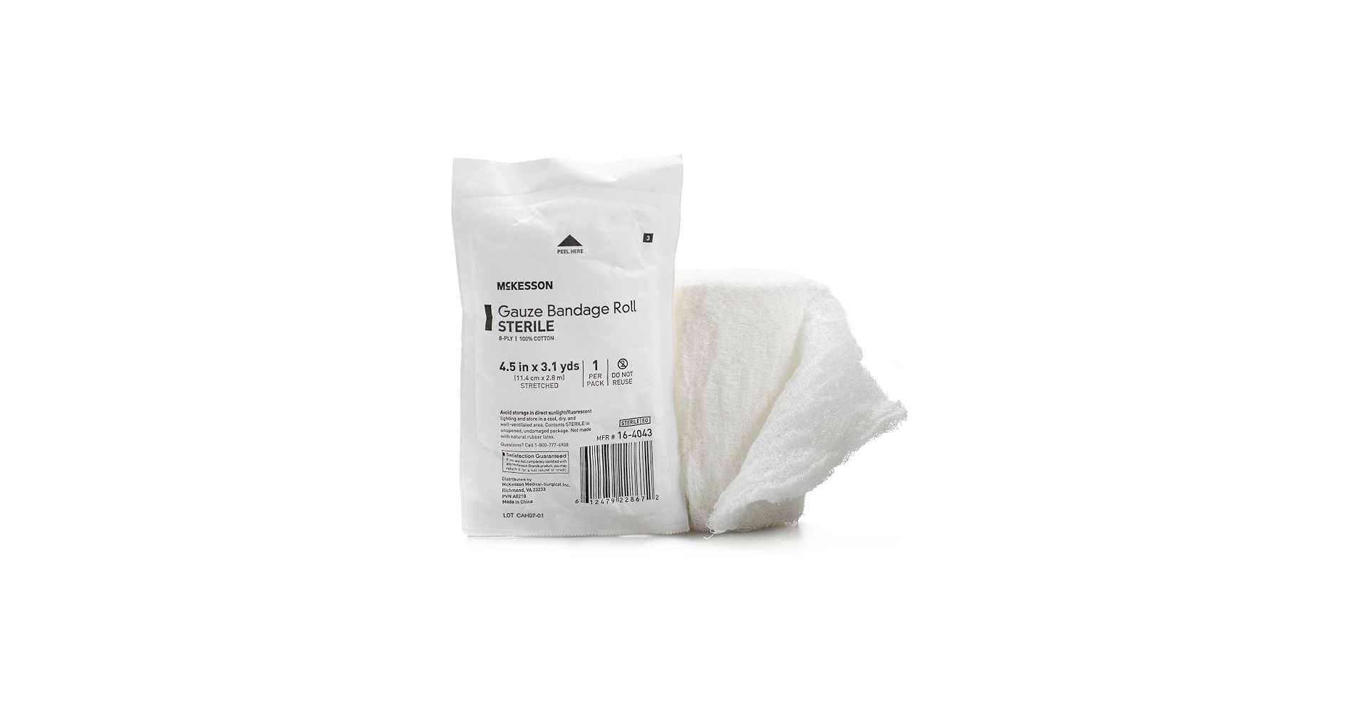 A roll of self-adherent vet wrap, sterile gauze pads, and blunt-tip scissors laid out neatly on a countertop